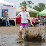 girl-splashing-in-mud-badass-bash