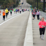 runners racing over bridge
