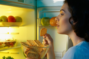 girl looking in refrigerator